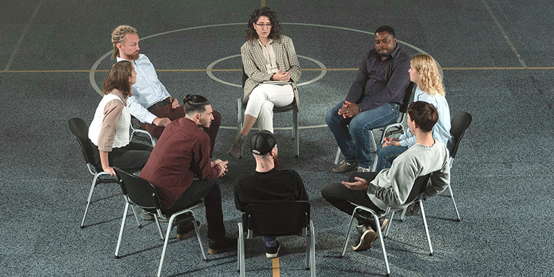 Farewell to international roots: a circle  of people sitting at chairs 